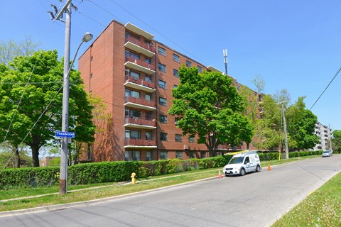 a van parked in front of an apartment building